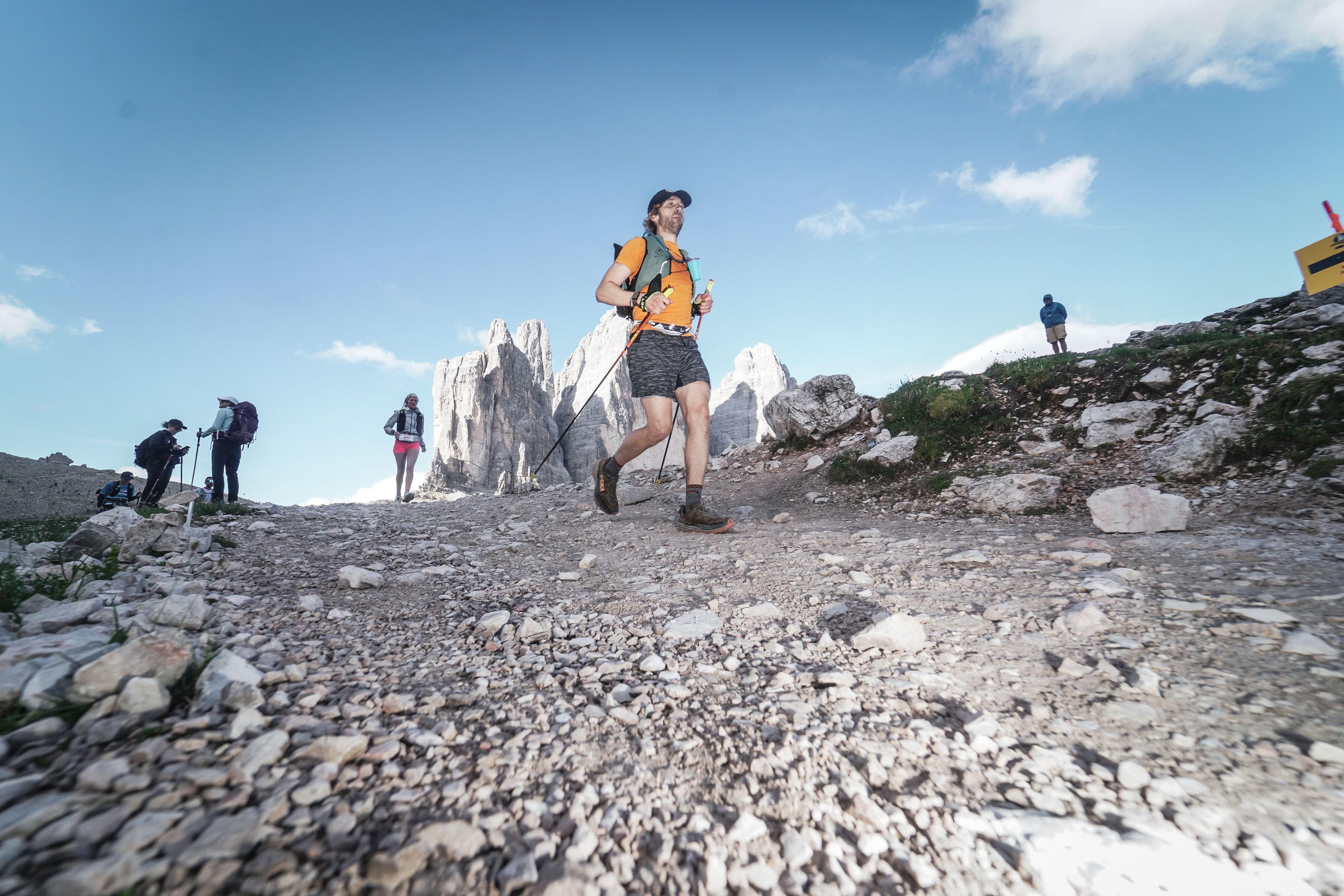 Trail runner powering uphill on rocky terrain